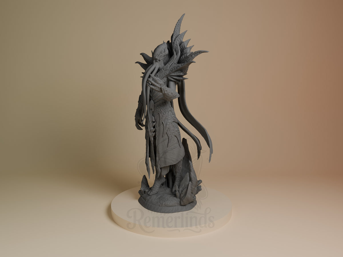 The Emperor resin figure from Baldur's Gate shown at an angle, displaying the character's elaborate headdress, robed torso, and flowing details on a cream base.