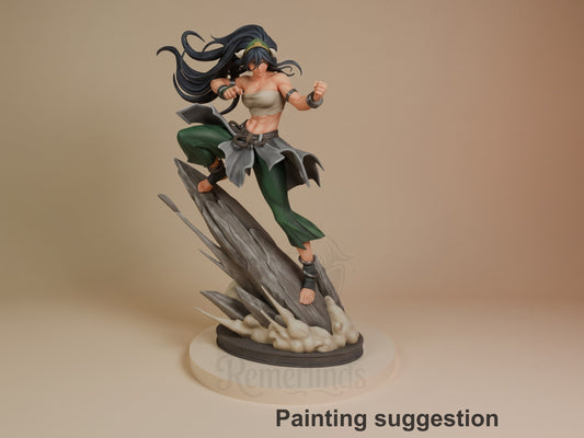 Painted Toph from Avatar: The Last Airbender lunges atop a sculpted rocky base as a resin figure.