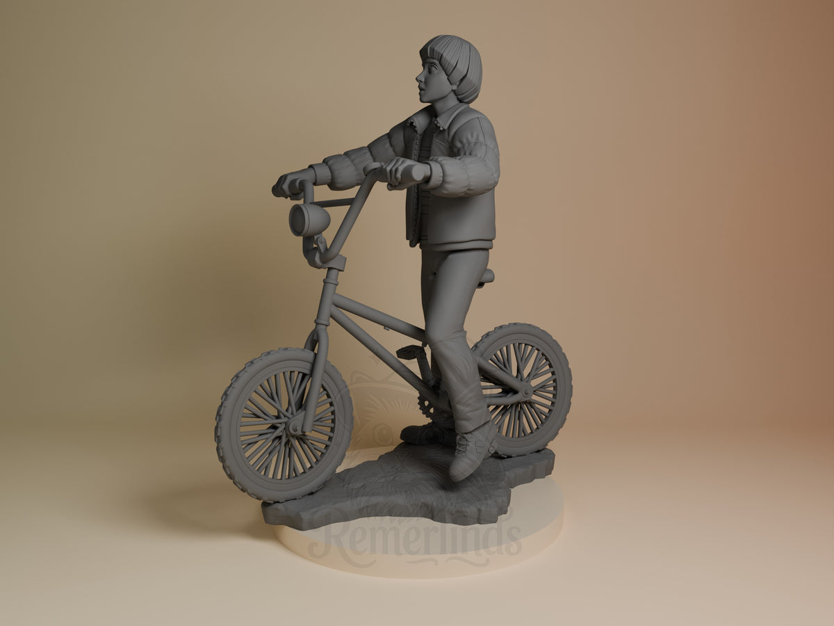 Will Byers from Stranger Things standing on a bicycle, 3D printed resin figure shown from the side angle, unpainted gray finish on cream base.