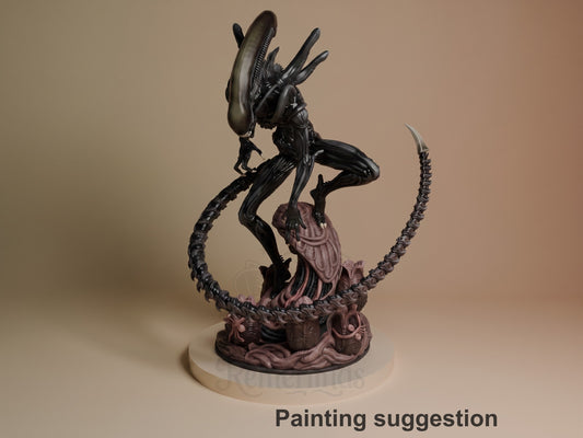 Xenobeast Broodling resin figure in dynamic pose on ornate base, black glossy body with mauve-purple details, elongated head with ridged spines, labeled painting suggestion.