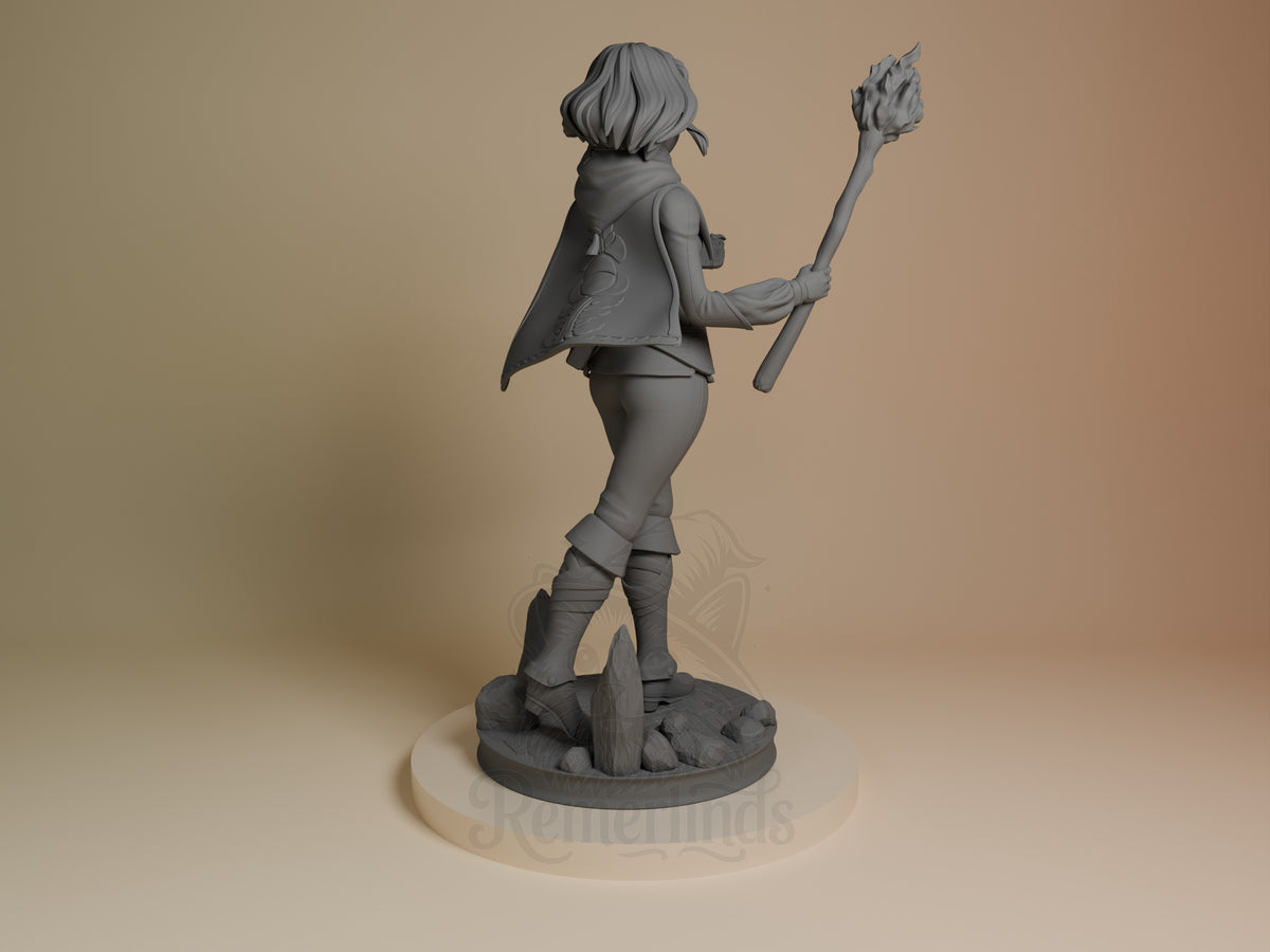 Princess Zalde resin figure from Tales of Daelz shown from back, holding staff aloft, wearing cape and boots on rocky base, unpainted gray.
