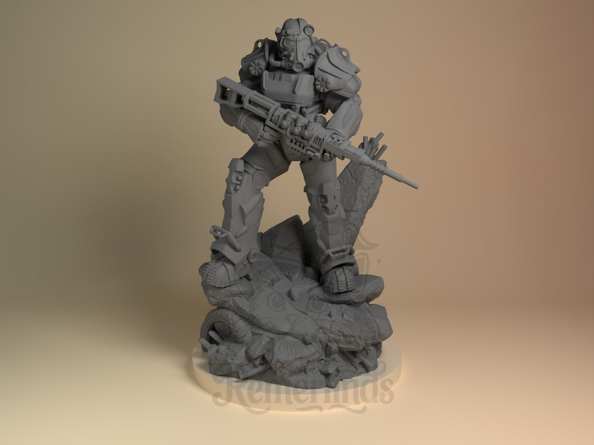 T60 Power Suit Post-Apocalypse Wasteland 3D printed resin figure by Nomnom, unpainted front view. The miniature figure depicts the T-60 Power Armor from the Fallout series in a dynamic standing pose, gripping a large futuristic rifle with both hands. The detailed resin sculpt emphasizes the mechanical armor plates and battle-worn base, featuring rubble and broken industrial elements that evoke a post-apocalyptic wasteland setting.