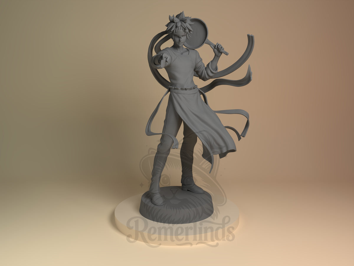 Soma Yukimura Cuisine Wars 3D printed resin figure by Nomnom, unpainted front view. The figure depicts Soma Yukihira in a poised and energetic stance, emphasizing his culinary prowess. The extended arm and raised frying pan create a sense of action and readiness, while the detailed apron ribbons add movement and flare to the composition. This dynamic pose and thoughtful details capture the character's essence as a confident and skilled chef.