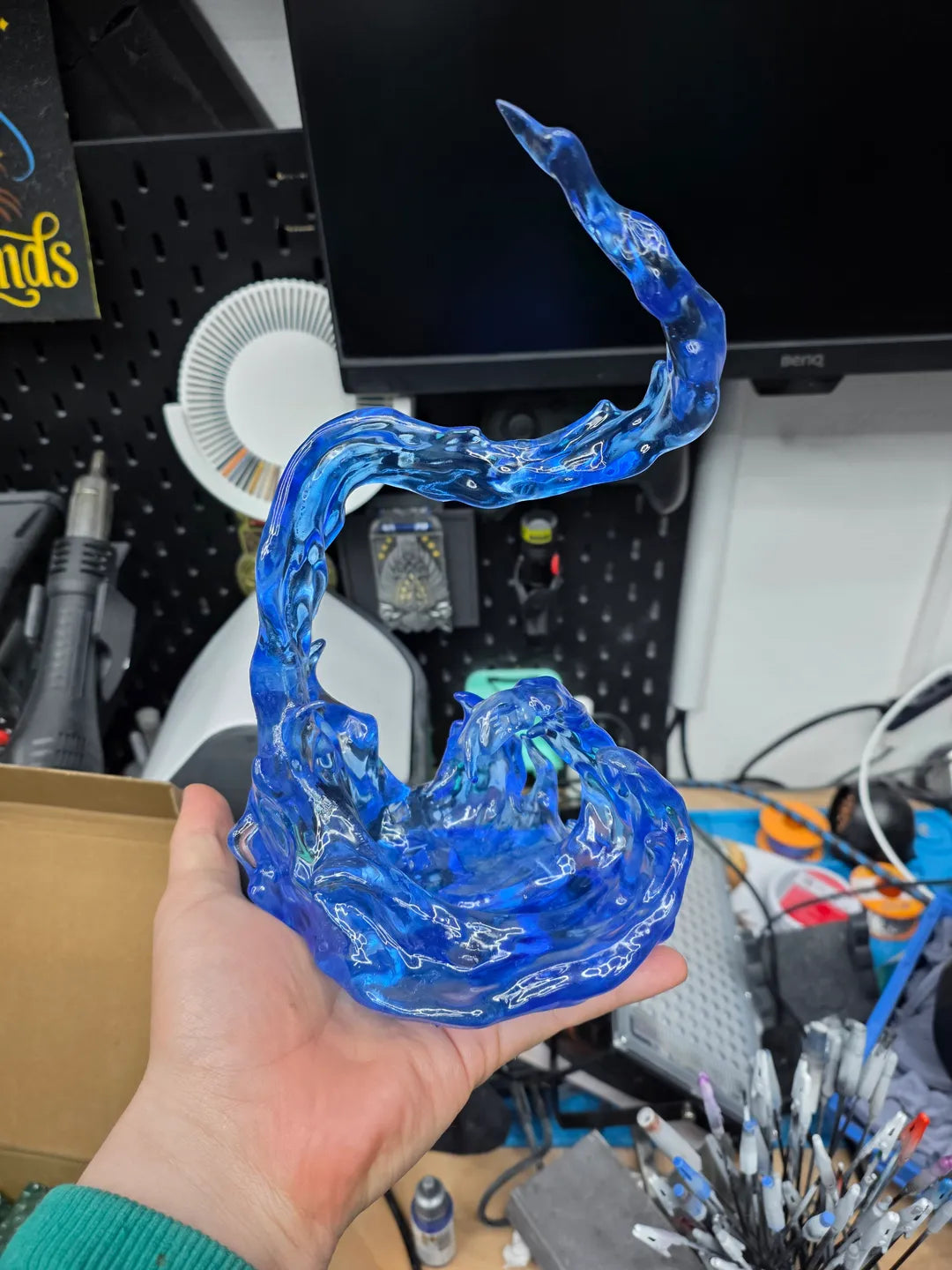 Fully transparent blue water effect part from a resin figure kit, clear-coated and held in hand